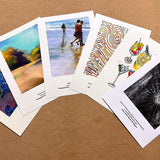 Collection of various printed cards on a brown surface