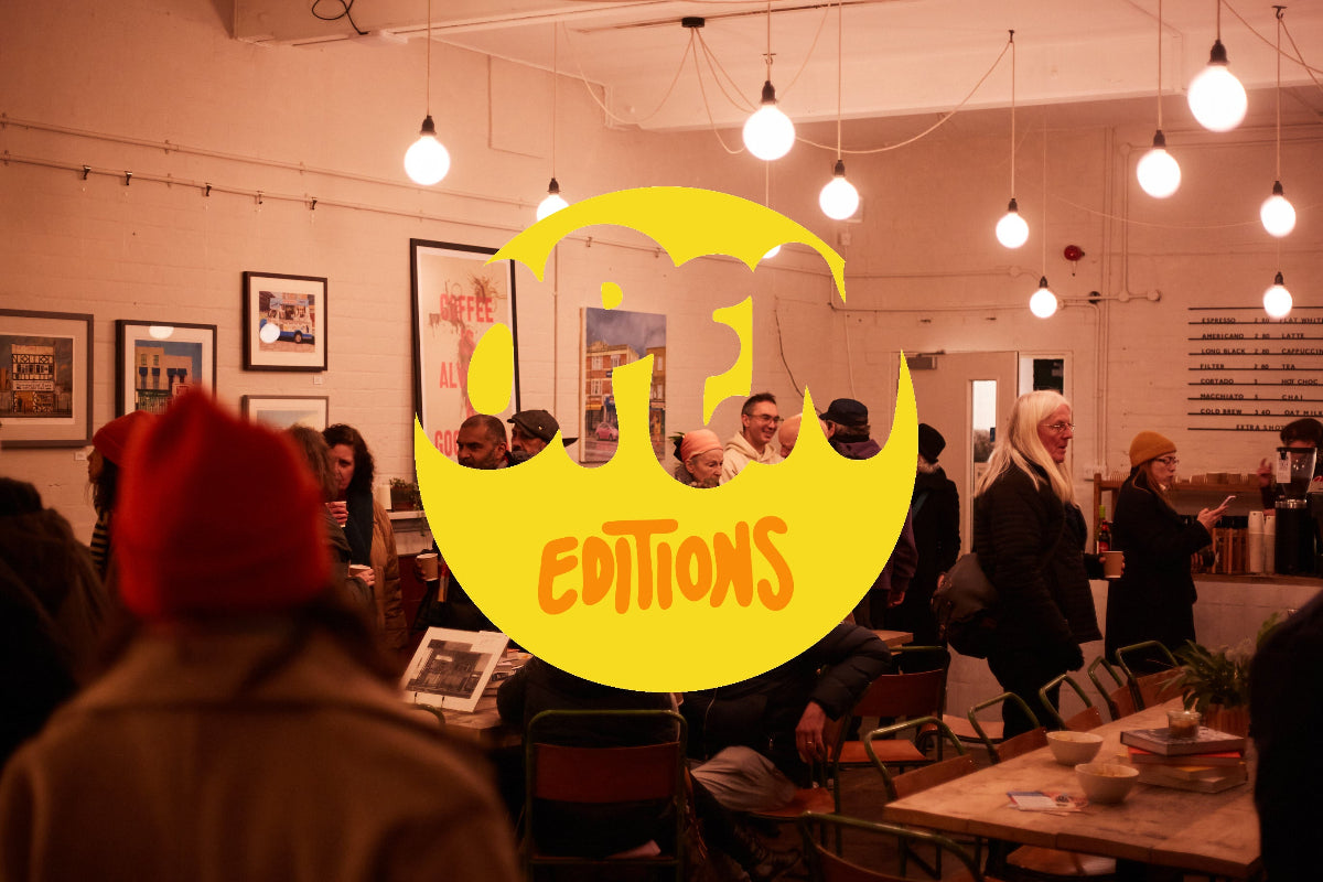 People in a room with a large yellow logo and text overlay