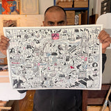Person holding a large framed artwork with various illustrations and text.